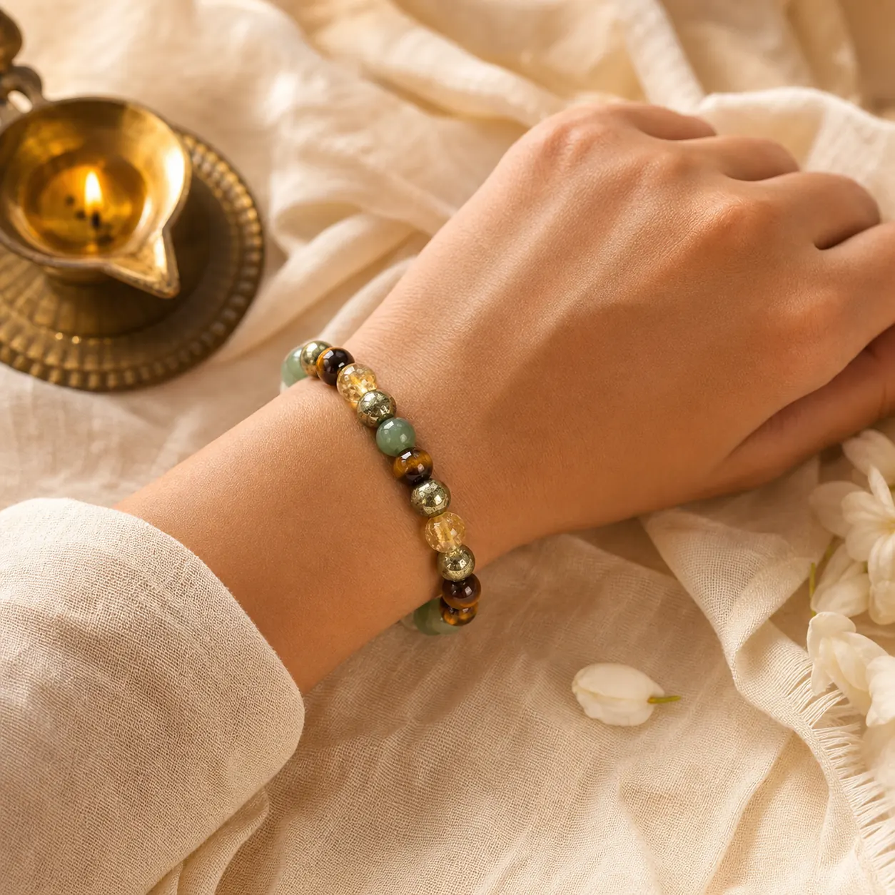 Energy-stone bracelet worn beside a ritual lamp